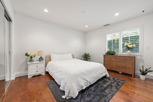 bedroom featuring dark hardwood / wood-style flooring and a closet