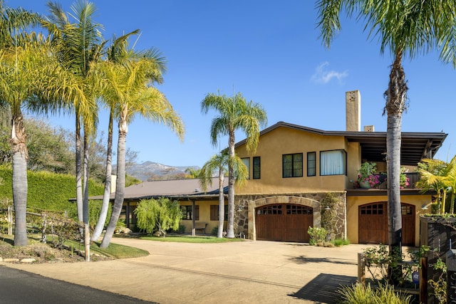 view of front of property with a garage and a mountain view