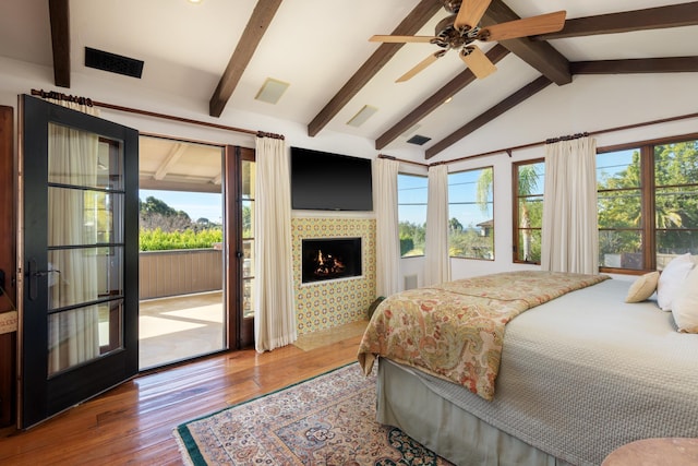 bedroom featuring ceiling fan, wood-type flooring, multiple windows, and access to outside