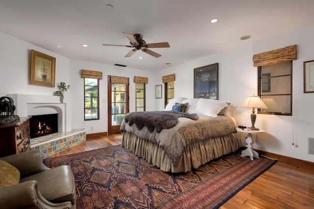 bedroom with ceiling fan and hardwood / wood-style floors