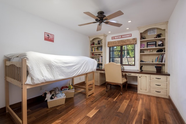 bedroom featuring dark hardwood / wood-style floors, built in desk, and ceiling fan