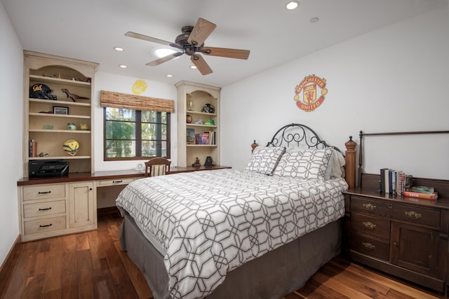 bedroom featuring dark hardwood / wood-style flooring, built in desk, and ceiling fan