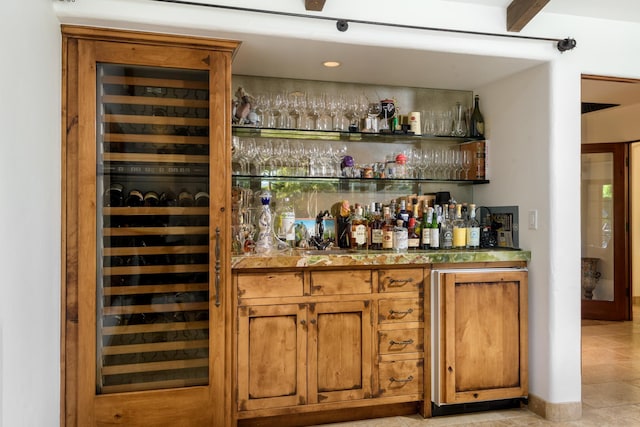 bar with light tile patterned floors and wine cooler