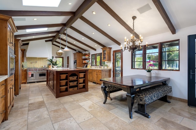 dining room with vaulted ceiling with beams and a chandelier