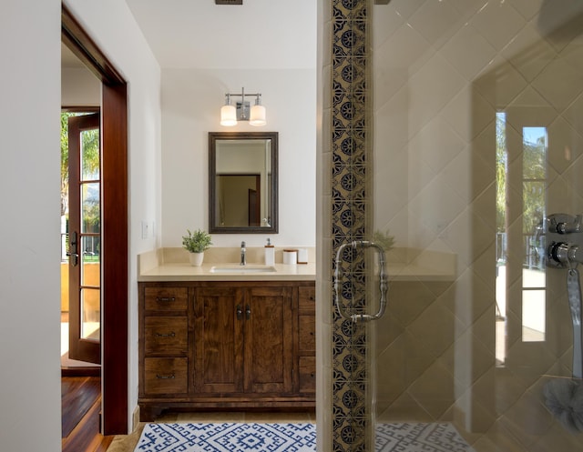 bathroom featuring vanity and tiled shower