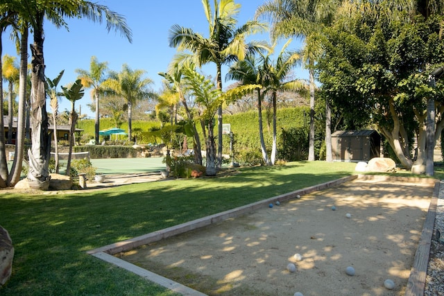 view of community with a yard and a storage shed