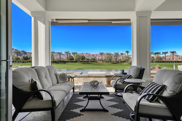 view of patio with an outdoor living space and a water view