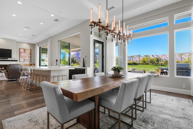 dining room with a mountain view, plenty of natural light, and a notable chandelier