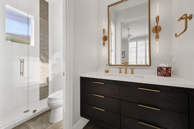 bathroom with a shower with shower door, vanity, tile patterned flooring, and toilet