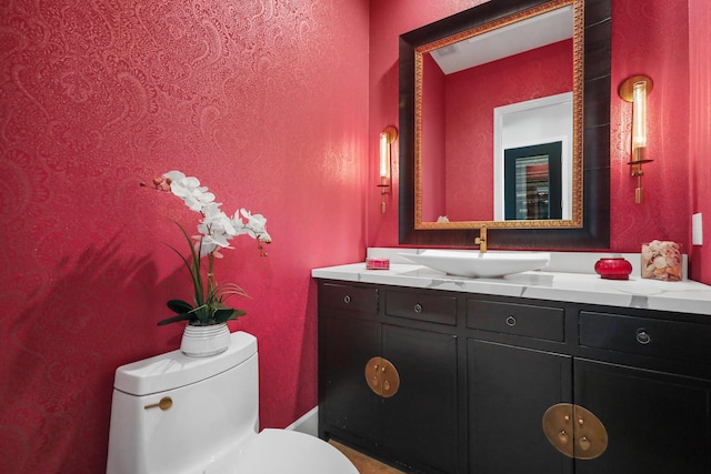 bathroom with toilet and vanity