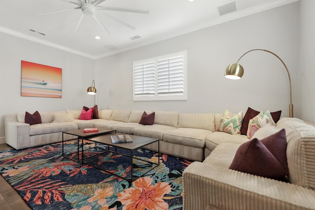 living room featuring ceiling fan and crown molding