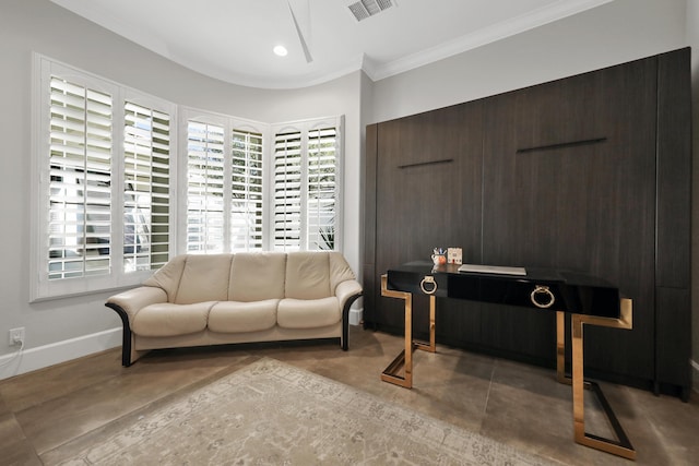 sitting room with concrete floors and ornamental molding