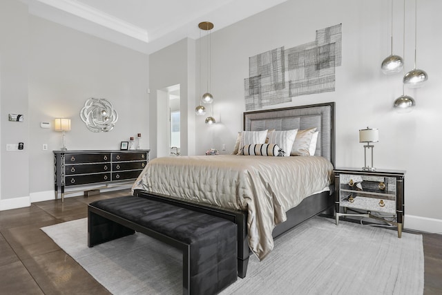 bedroom with a high ceiling and crown molding