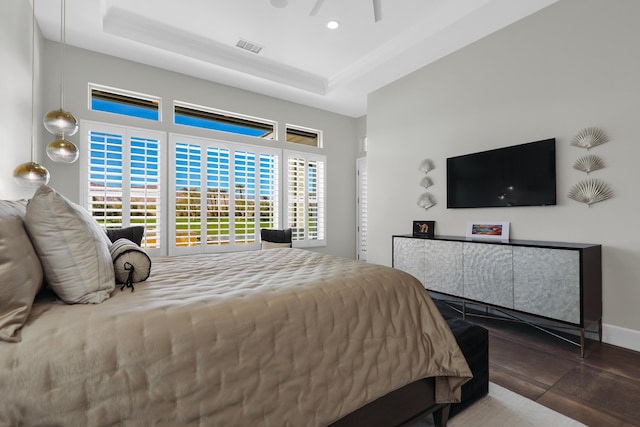 bedroom featuring ceiling fan and a tray ceiling