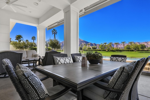 view of patio / terrace with ceiling fan and a mountain view