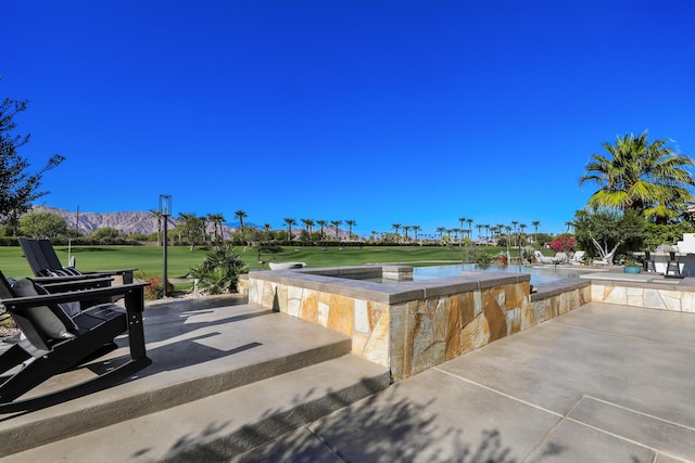 view of patio featuring a water and mountain view