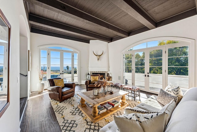 living room featuring french doors, plenty of natural light, wood ceiling, and hardwood / wood-style flooring