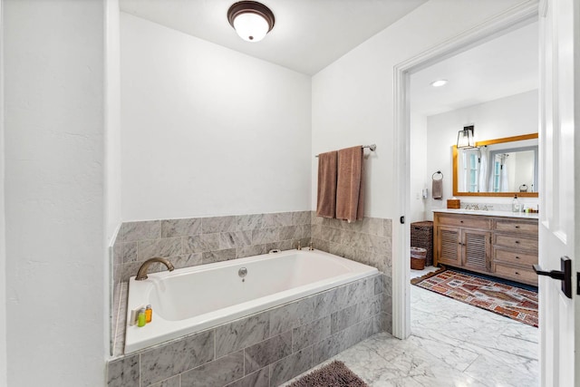 full bath with marble finish floor, a bath, and vanity