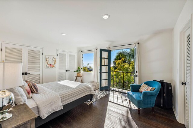 bedroom with recessed lighting, two closets, wood-type flooring, and access to outside