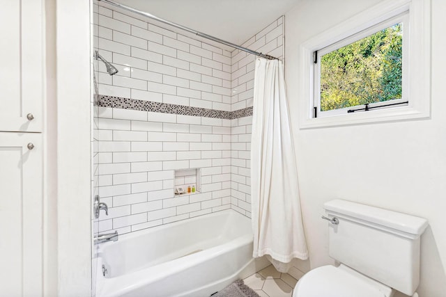 bathroom featuring tile patterned flooring, toilet, and shower / bath combo with shower curtain