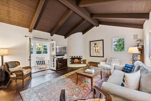 living area featuring lofted ceiling with beams, a large fireplace, hardwood / wood-style floors, and wooden ceiling