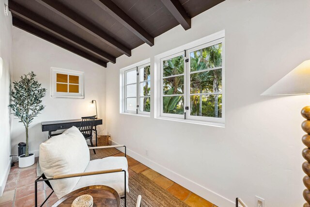 living area with lofted ceiling with beams and baseboards