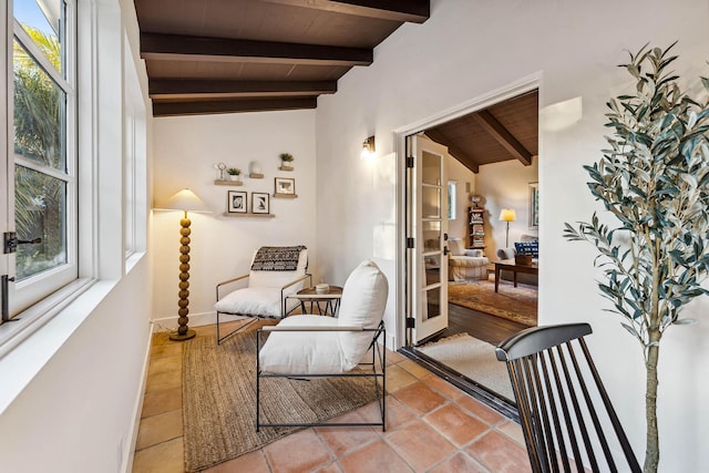 sitting room featuring a wealth of natural light, wooden ceiling, lofted ceiling with beams, and light tile patterned flooring