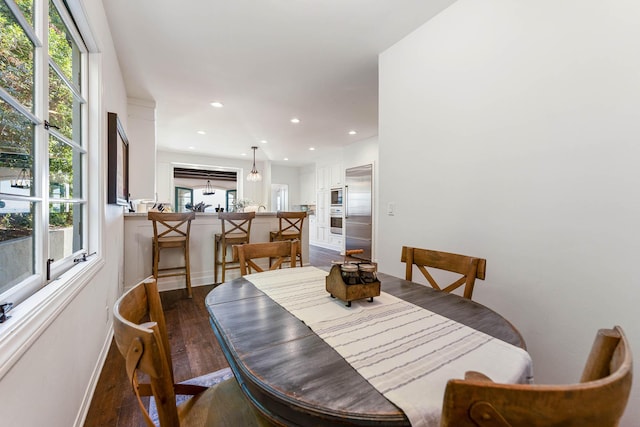 dining space featuring a wealth of natural light, recessed lighting, dark wood-type flooring, and baseboards