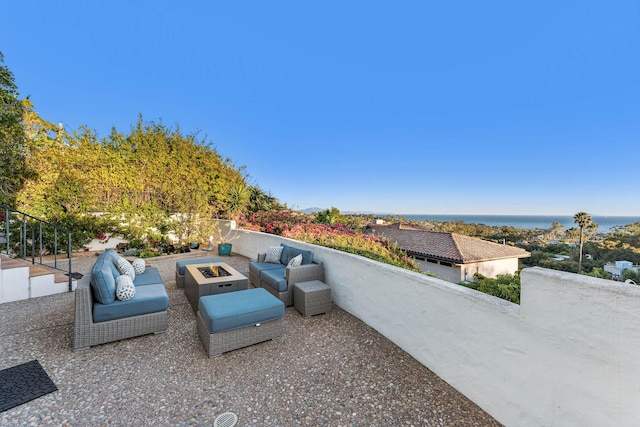 view of patio featuring an outdoor living space with a fire pit