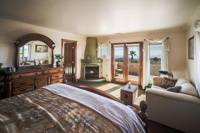 bedroom with crown molding, access to outside, a large fireplace, and french doors