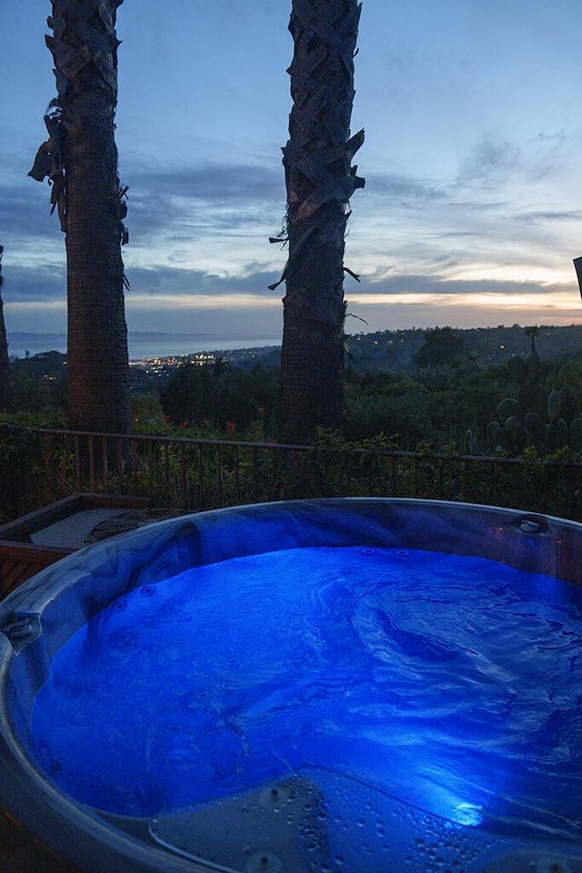 view of pool at dusk