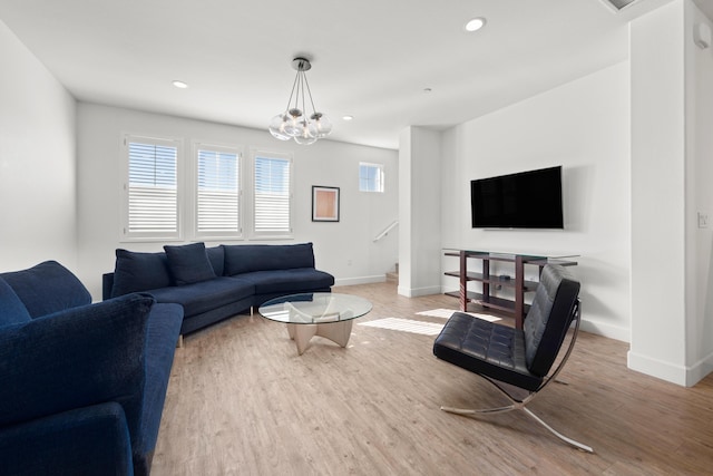 living room with wood-type flooring and a notable chandelier