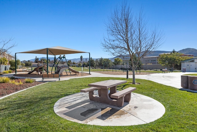 surrounding community with a yard and a playground