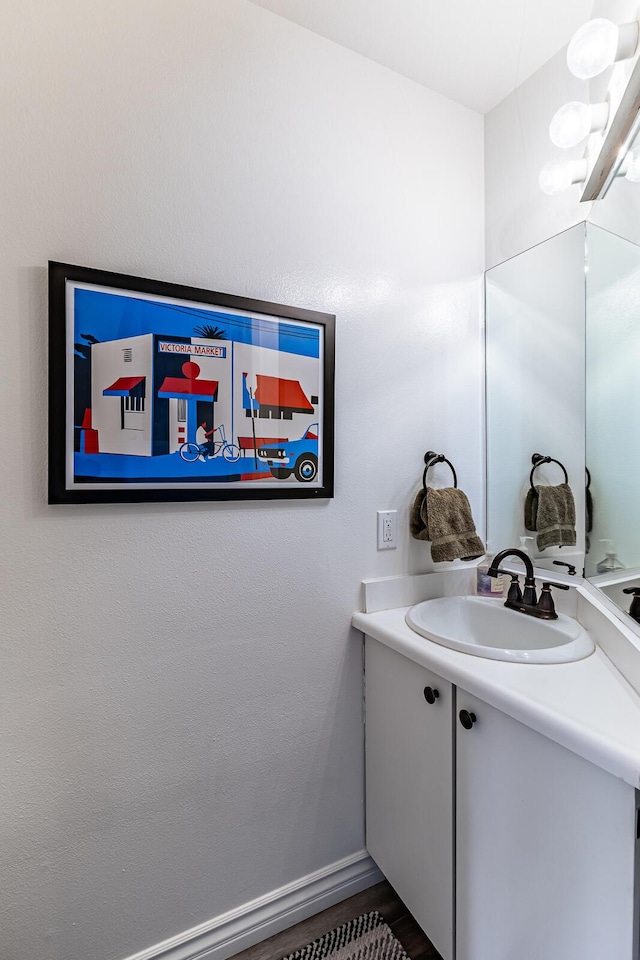 bathroom with vanity and hardwood / wood-style floors