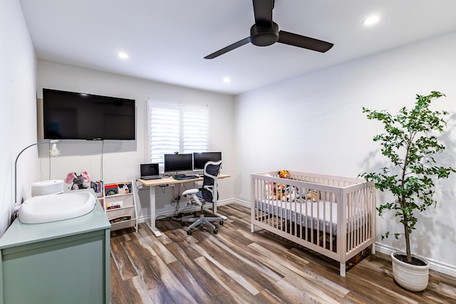 bedroom with dark hardwood / wood-style flooring and ceiling fan