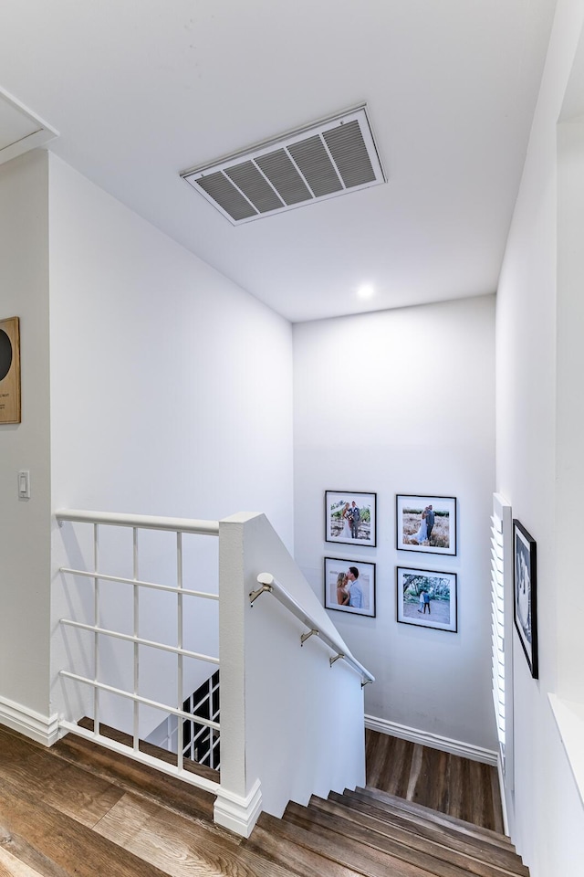 staircase with hardwood / wood-style flooring