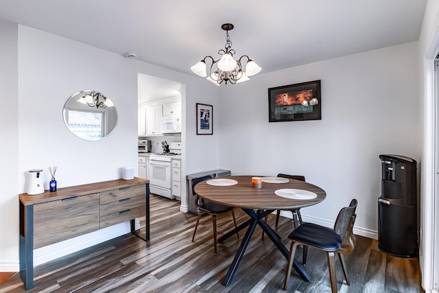 dining space with dark hardwood / wood-style floors and a chandelier