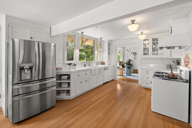 kitchen featuring decorative light fixtures, stainless steel refrigerator with ice dispenser, light hardwood / wood-style flooring, white cabinets, and range