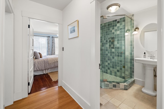 bathroom featuring ornamental molding, hardwood / wood-style floors, and walk in shower