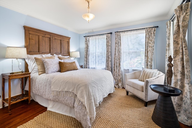 bedroom with crown molding and hardwood / wood-style flooring