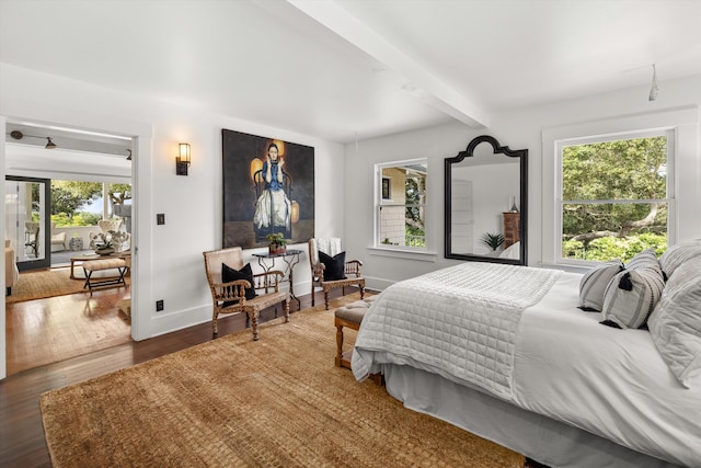 bedroom featuring dark hardwood / wood-style floors and beam ceiling