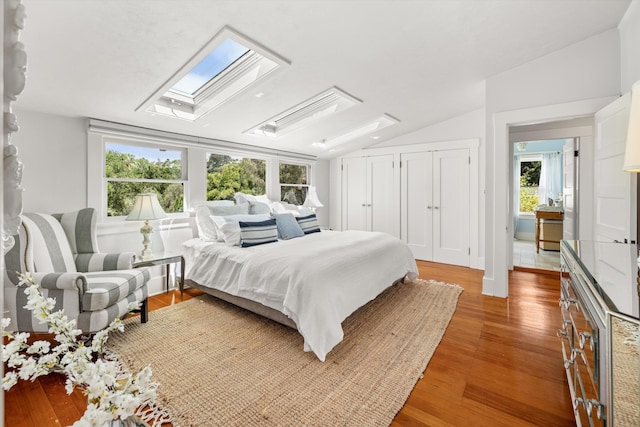 bedroom featuring hardwood / wood-style flooring and vaulted ceiling