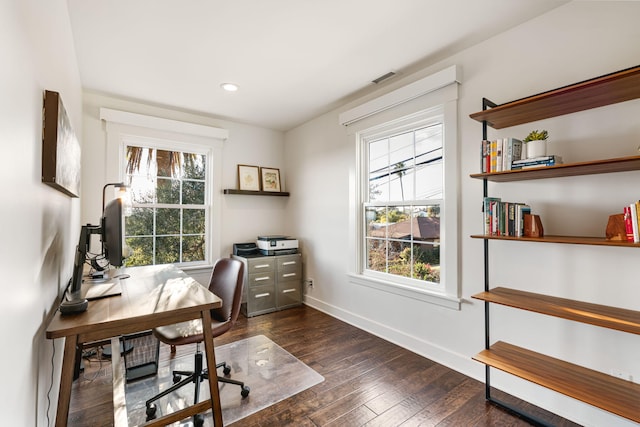 office area with a wealth of natural light and dark hardwood / wood-style floors