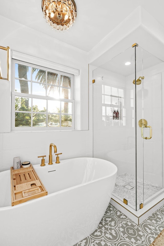 bathroom with tile patterned floors and plus walk in shower