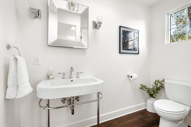 bathroom with toilet and hardwood / wood-style floors