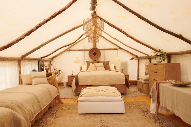 bedroom featuring vaulted ceiling with beams