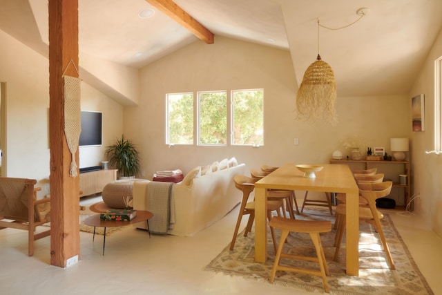 dining room featuring vaulted ceiling with beams