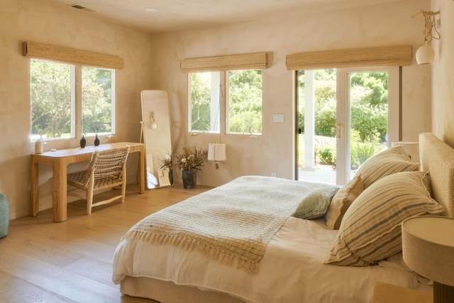 bedroom featuring light wood-type flooring and access to exterior