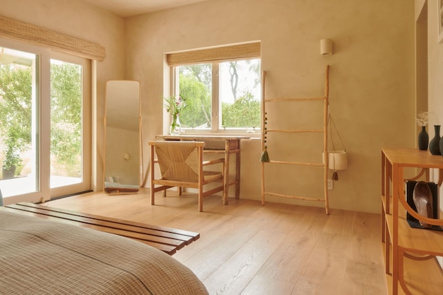 bedroom with light wood-type flooring and access to outside