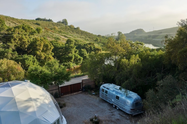 view of parking / parking lot with a water and mountain view